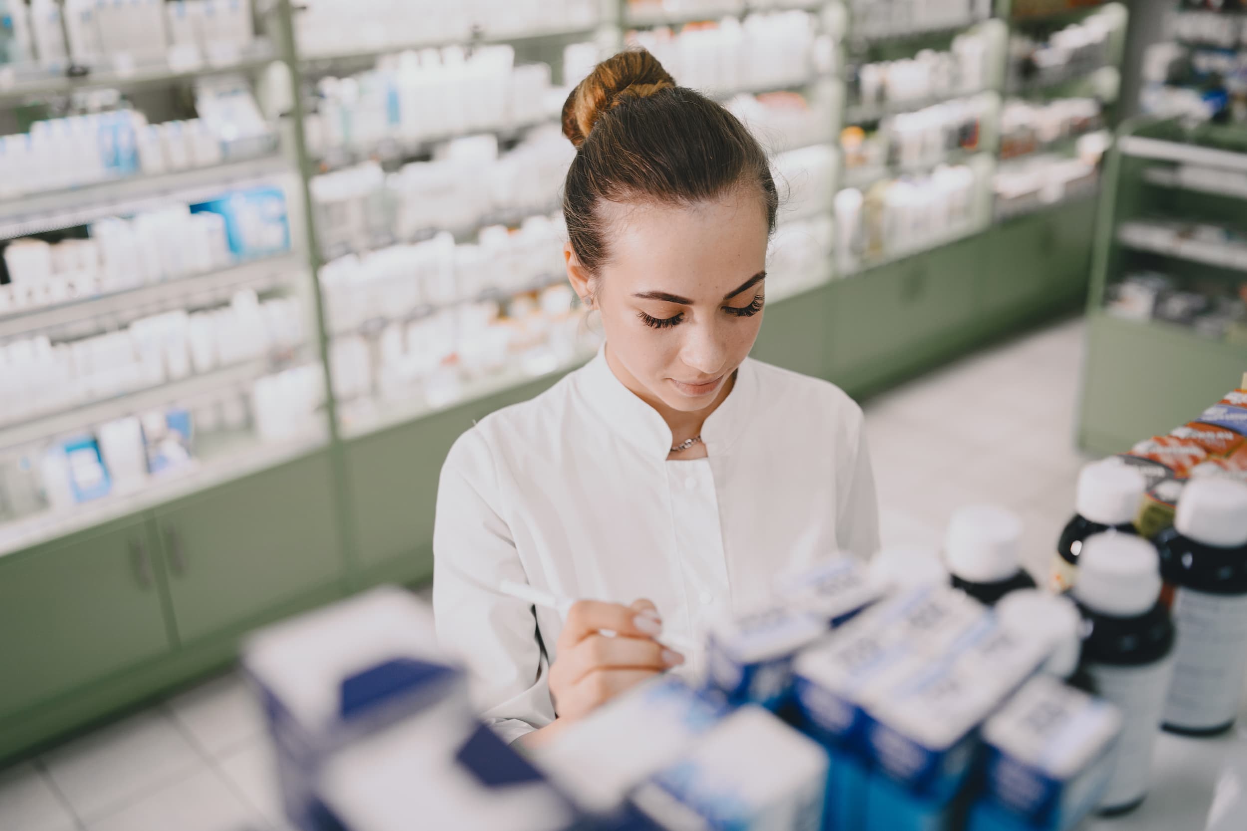 young-female-pharmacist-checking-medicine-in-chemist