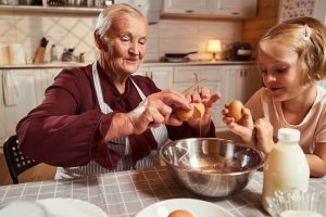 Nonna and child bake together in old style kitchen