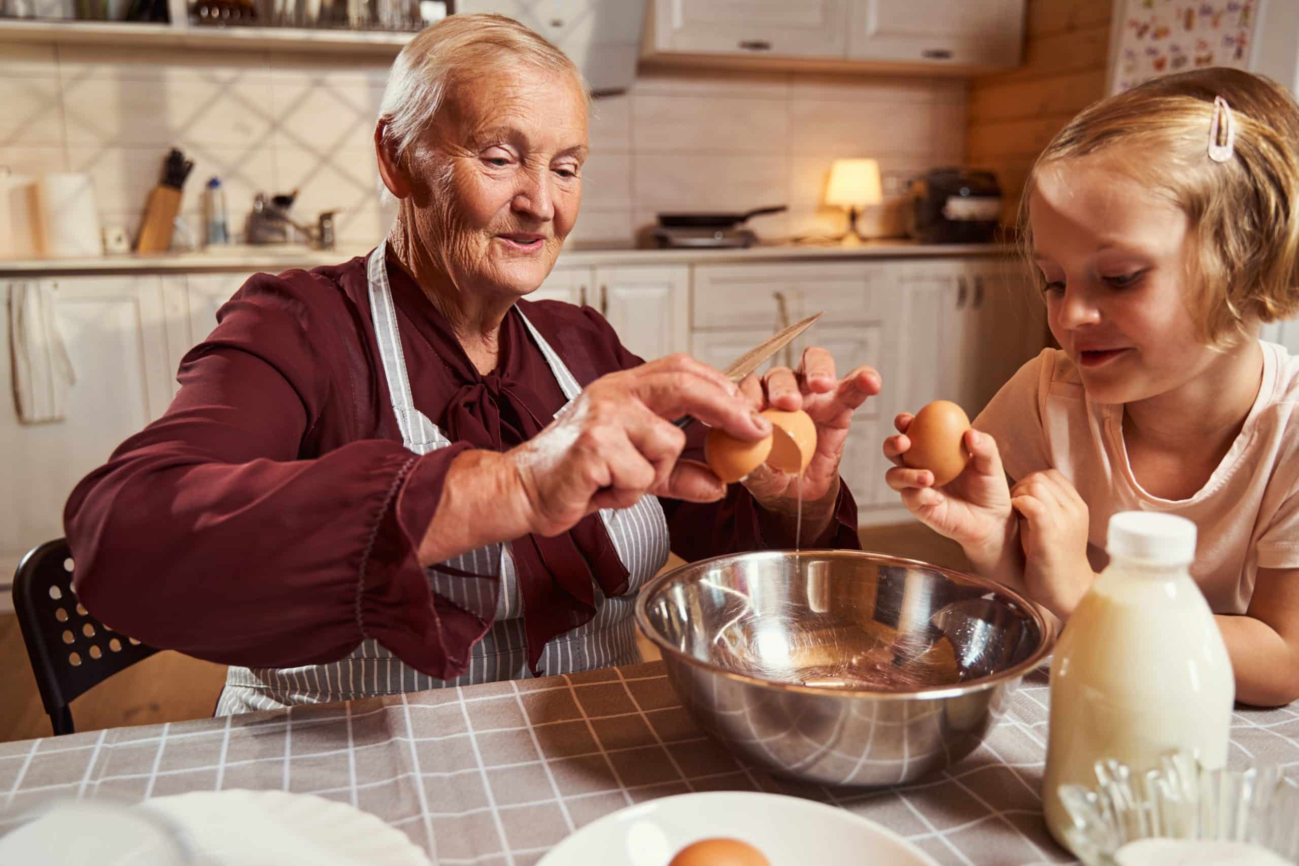 Nonna and child bake together in old style kitchen